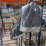 A 30 metre long ladder conveyor transports garments up to a 10 metre high mezzanine at ASOS, Barnsley